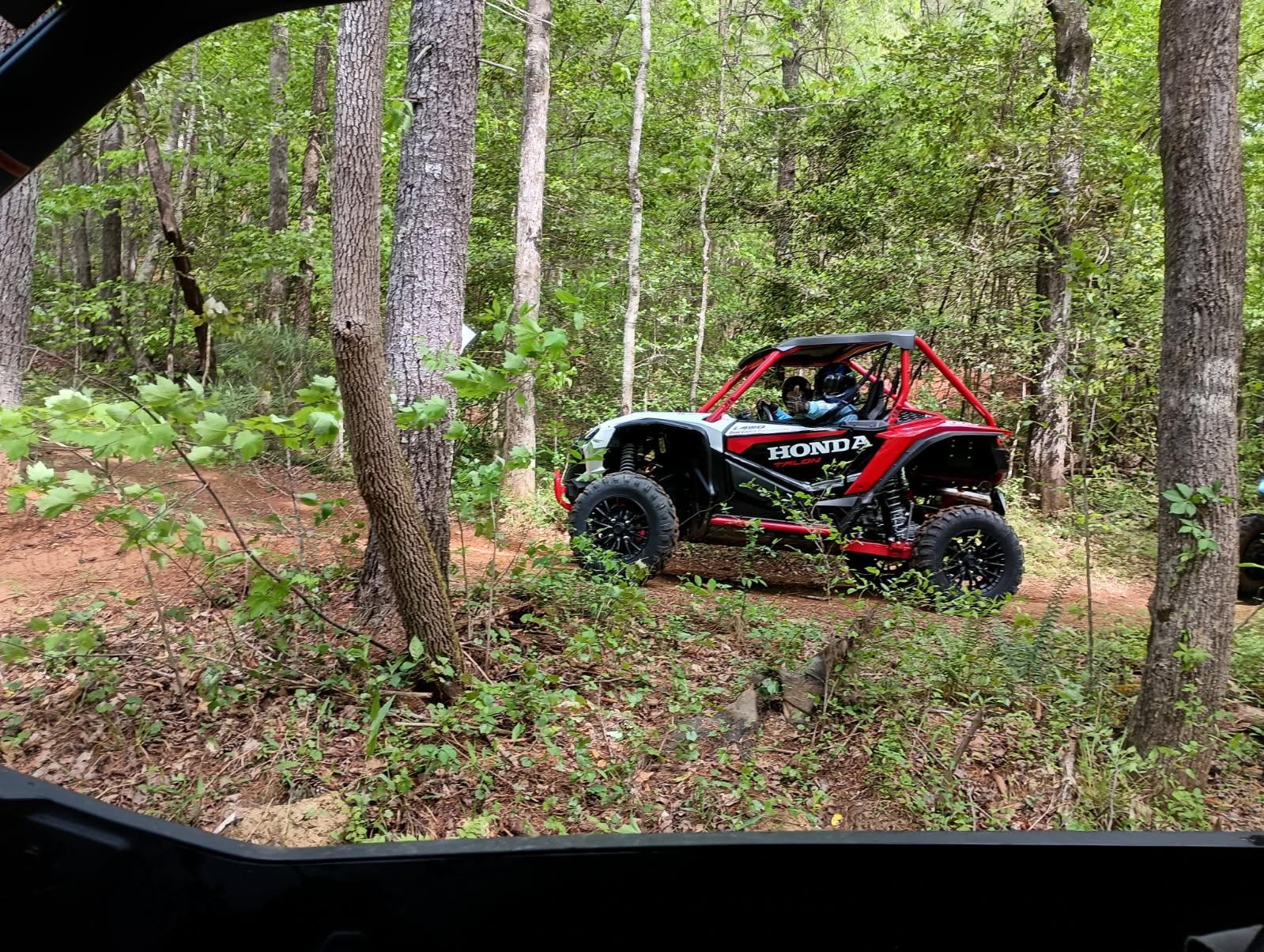 Group of UTVs parked on mountain trail