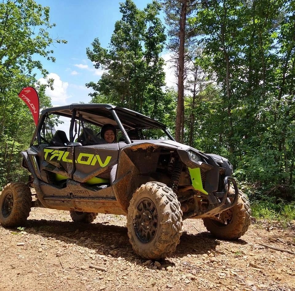 Convoy of UTVs on forest trail in autumn